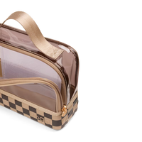 A clear plastic toiletry bag with a beige handle, gold zipper, and a brown and beige checkerboard patterned base, shown on a white background.