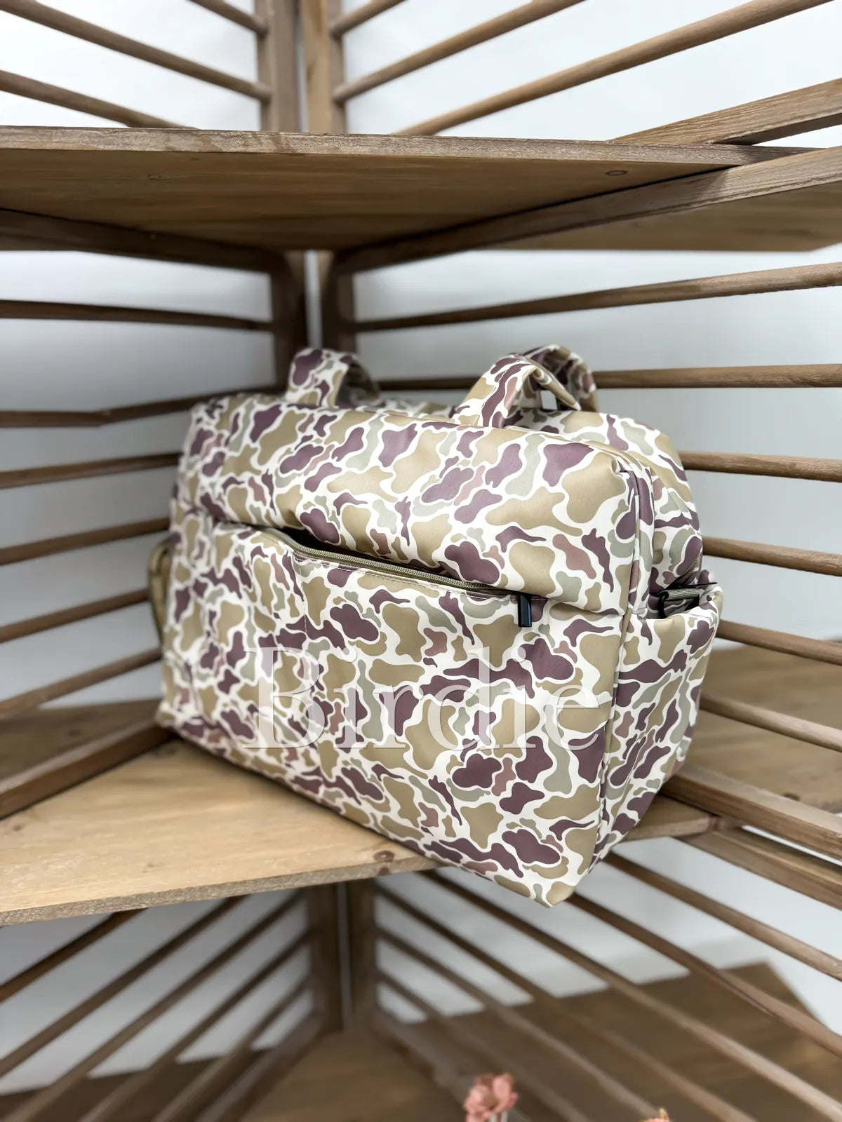 Camouflage-patterned bag on a wooden shelf