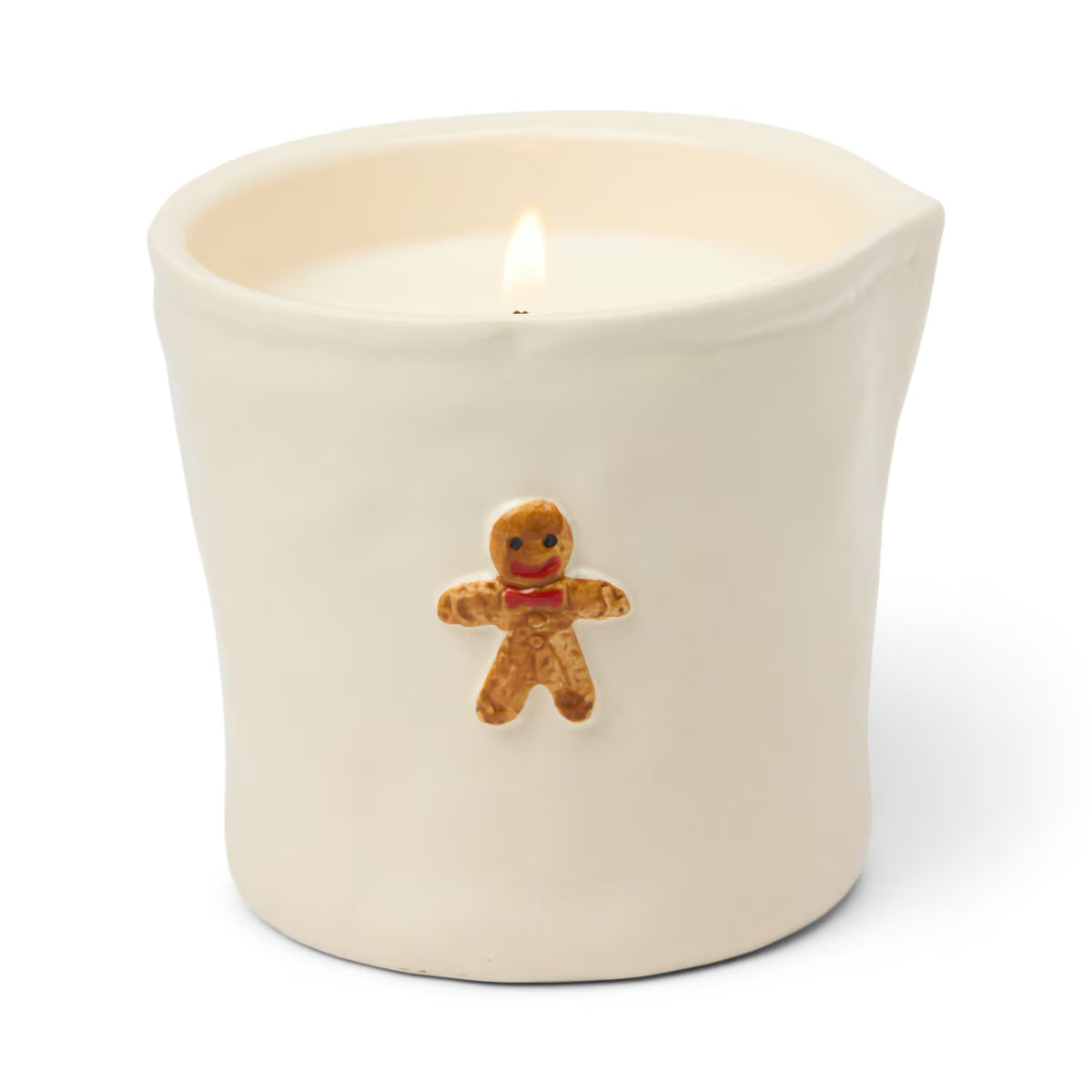 Candle in a white container with a gingerbread man decoration on a white background