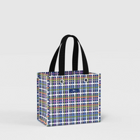 A tote bag with a colorful plaid pattern and black shoulder straps, shown on a light gray background.