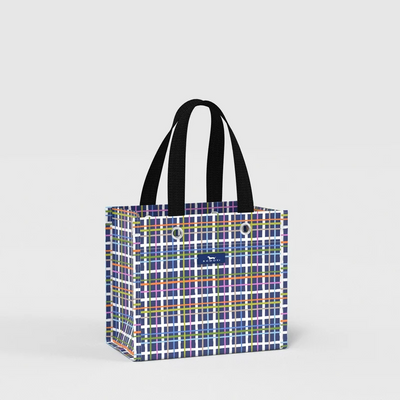 A tote bag with a colorful plaid pattern and black shoulder straps, shown on a light gray background.