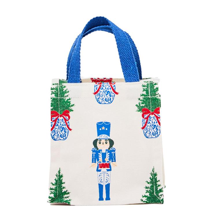 Small tote bag with Christmas-themed design featuring nutcrackers and trees on a white background.